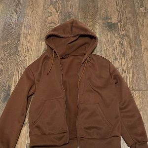 This is a cute brown zip up sweater that goes good with almost any cute top.